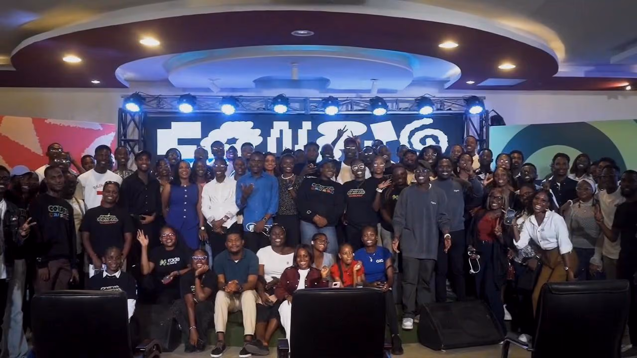 The Config Watch Party crowd gathers for a group photo in front of the stage
